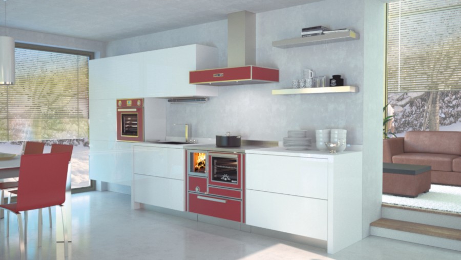 weiße Küche mit roten Küchenherd. Im Hintergrund eine braune Couch